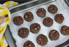 Biscoitos de chocolate sobre uma assadeira, no depoimento de Larissa C.